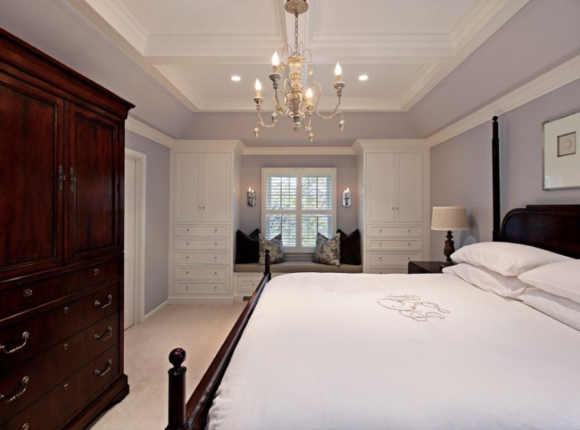 主要卧室以浅灰色的墙壁和迷人的吊灯照亮的壮丽天花板。客房配有巨大的舒适床和带抽屉的衣柜。